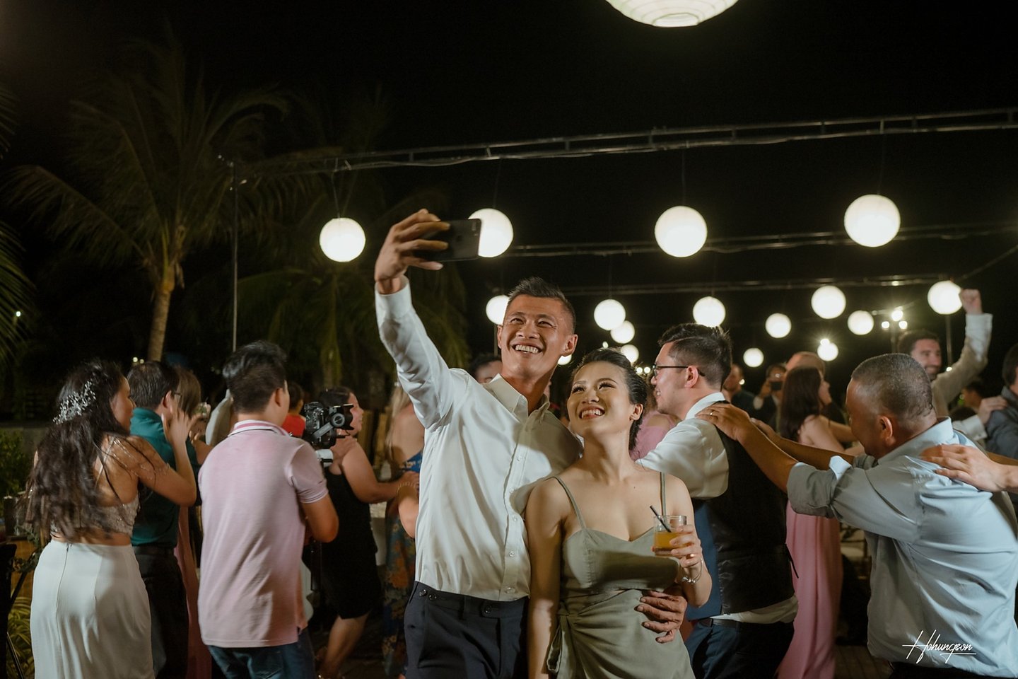 a man and woman dancing at a party
