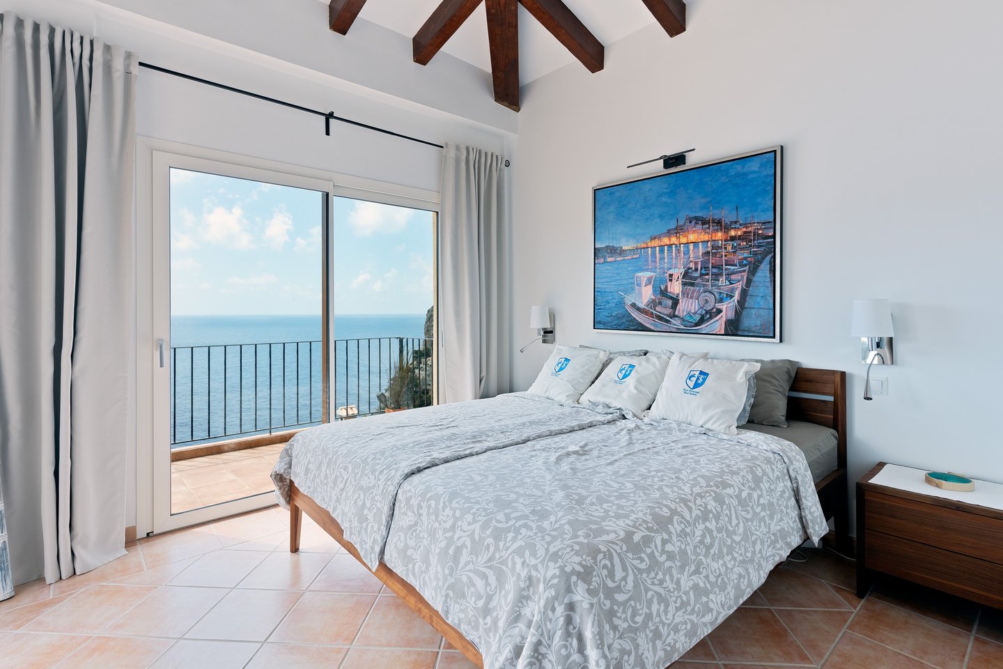 a bedroom with a large painting on the wall