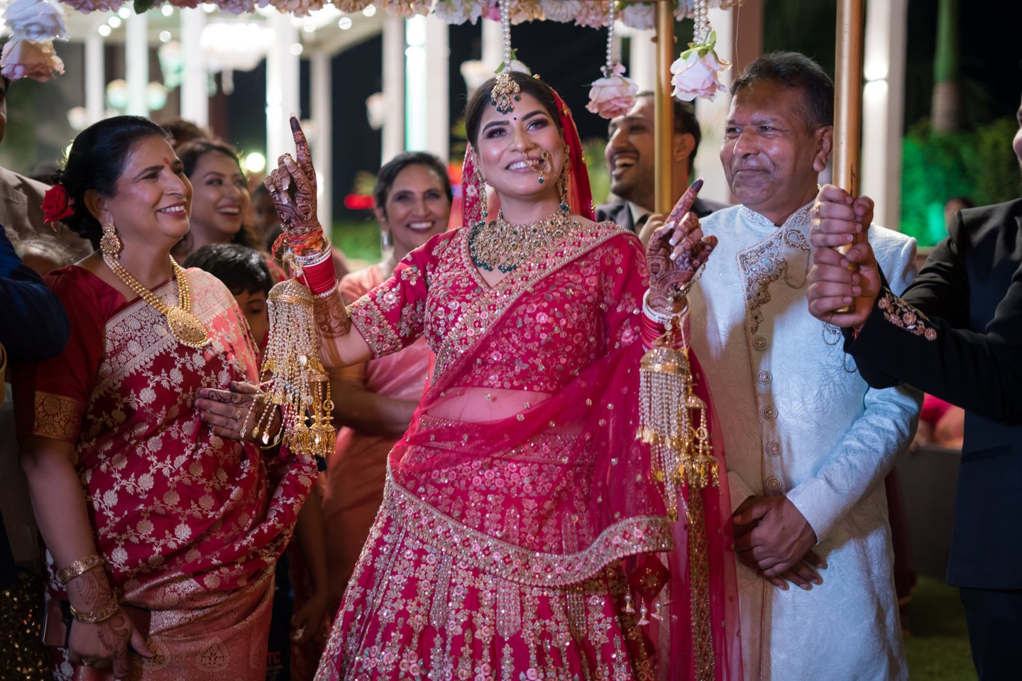 Bride in red lehenga at her wedding.