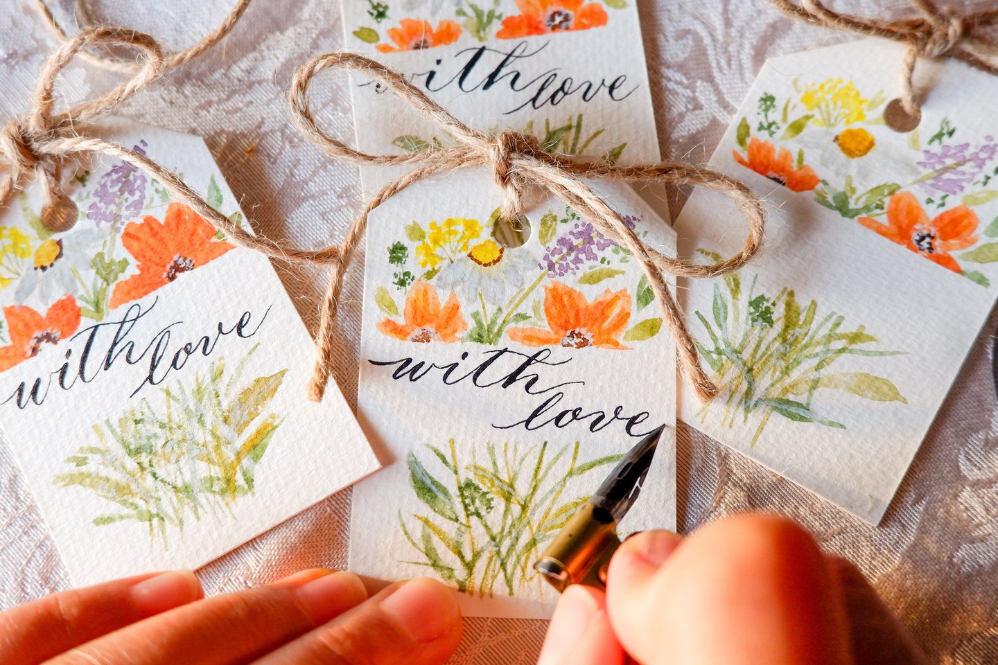 NYC calligrapher writing custom gift tags for a live event.
