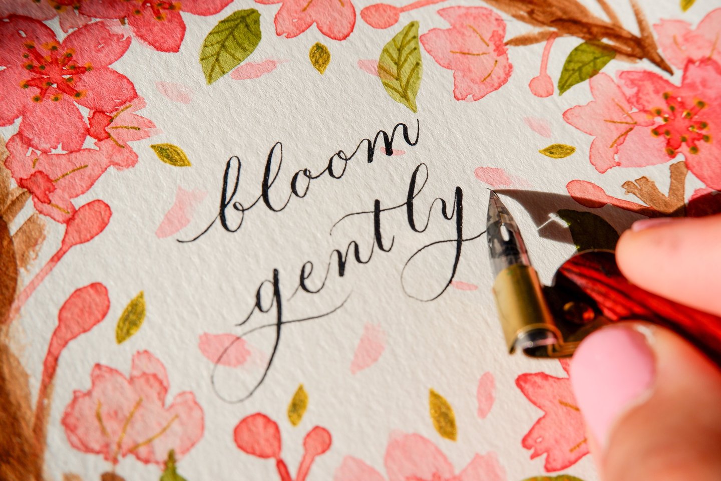 New York City Calligrapher writing inspirational quote customizing a watercolor floral painting