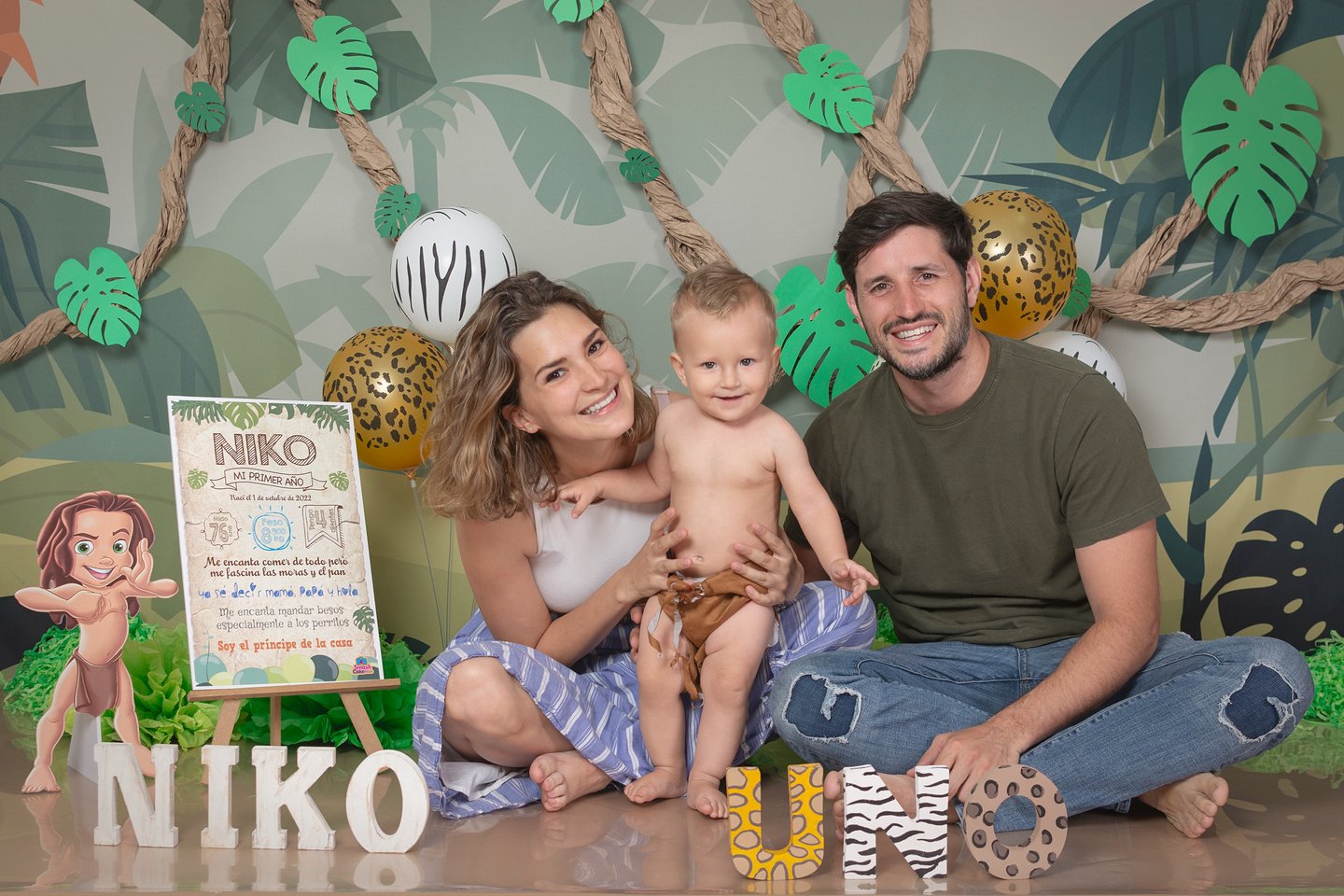 a man and woman sitting on a table with a sign that says nikkoo