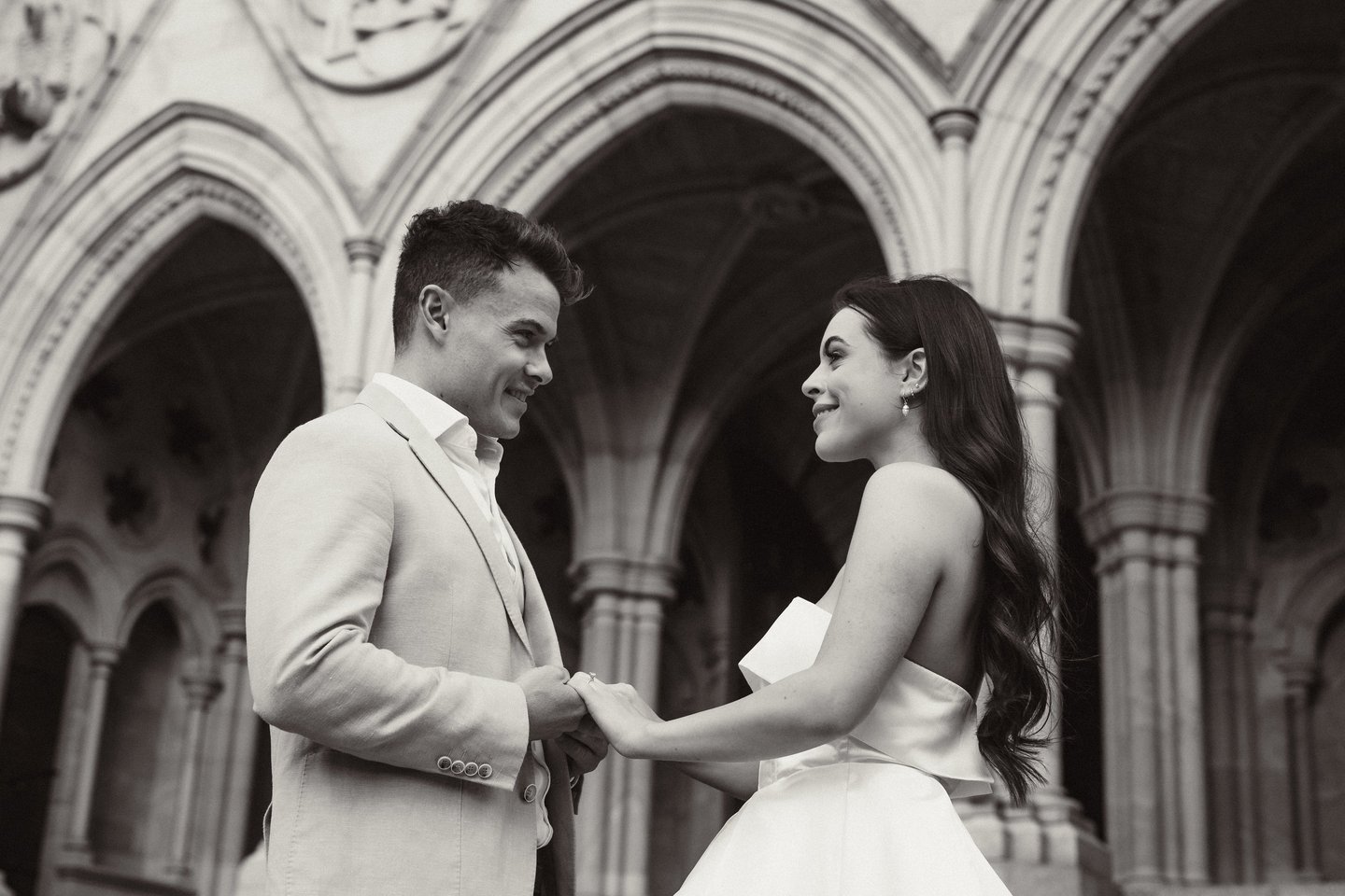 a man and woman standing in front of a building