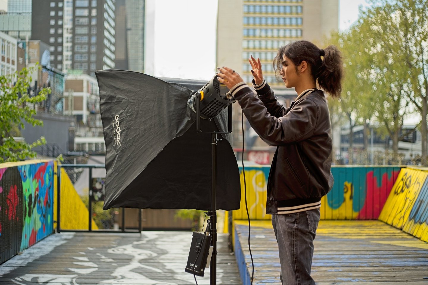 Youth setting up a video light