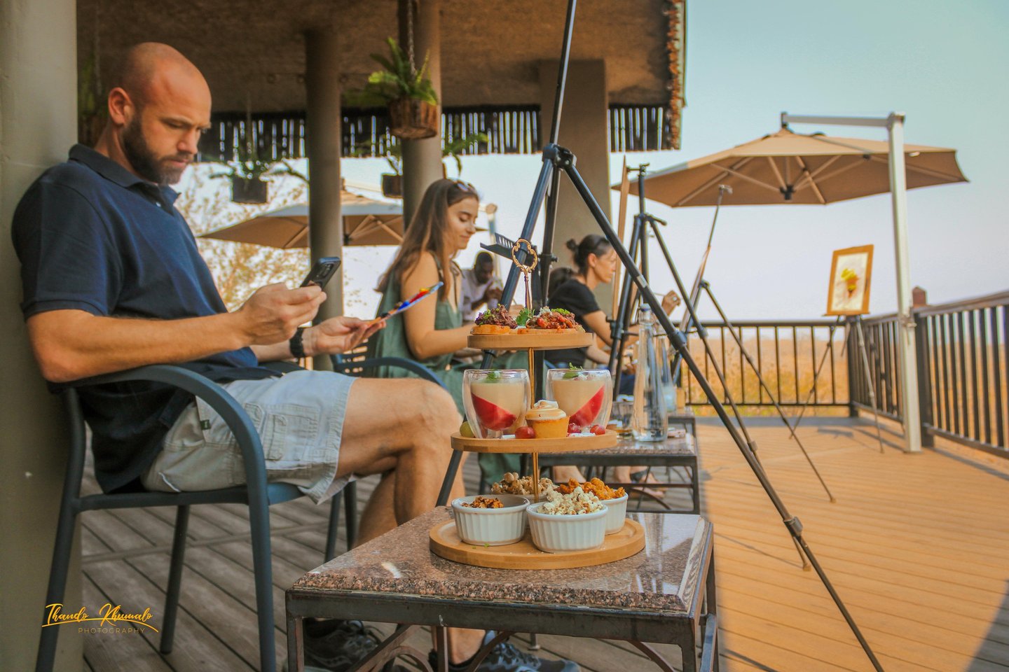 a man sitting on a table with food and drinks
