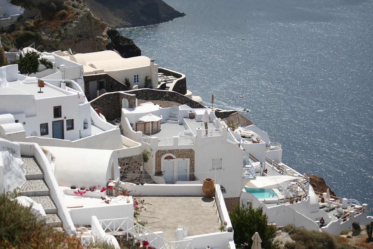 a house with a pool and a view of the ocean