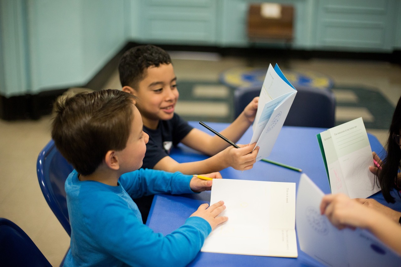Students discuss their workbook reflections.