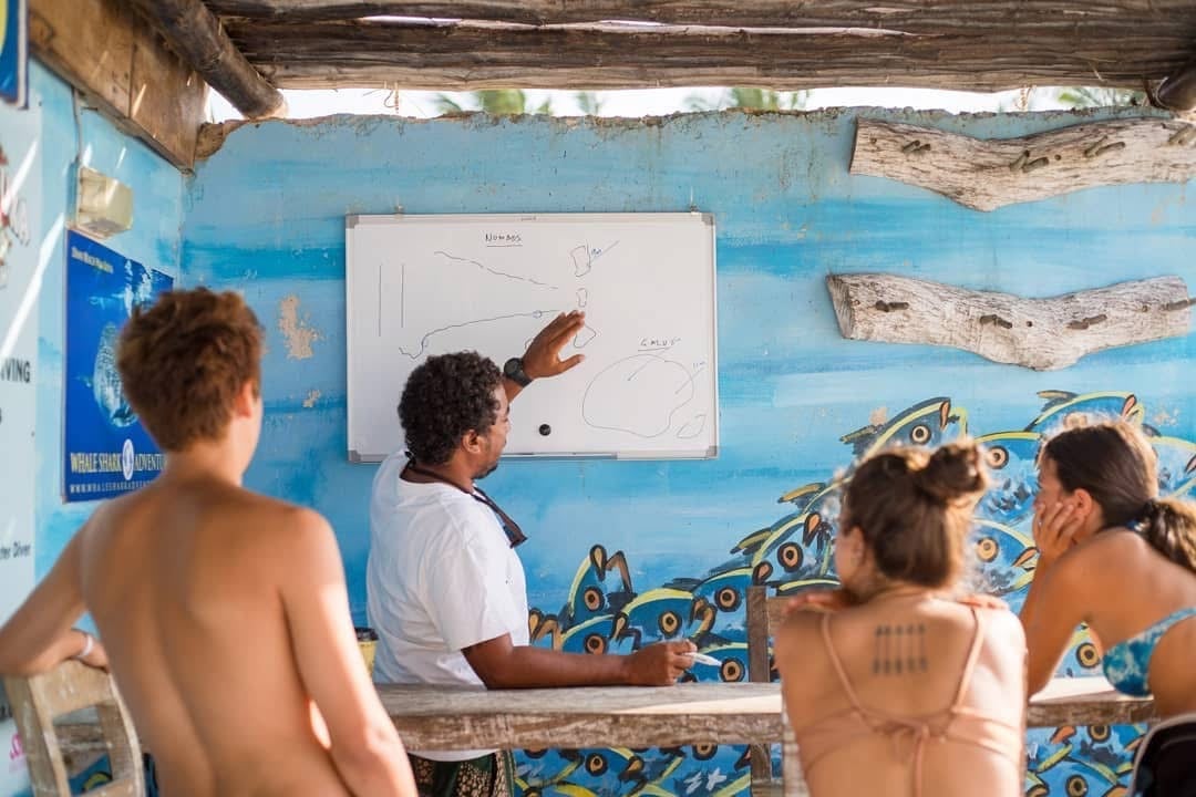 a scuba duka instructor briefing divers