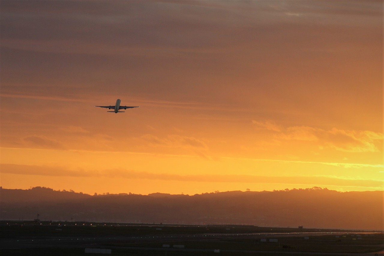 Airliner, airplane takeoff at sunset or sunrise