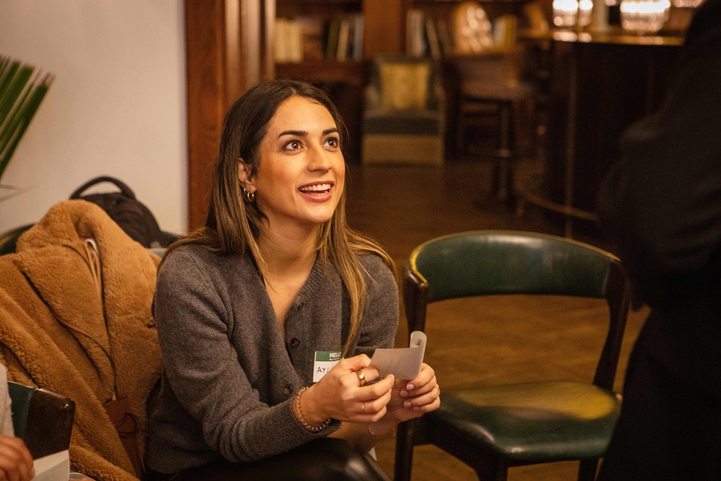 Female workshop participant, smiling during public speaking exercise in Berlin