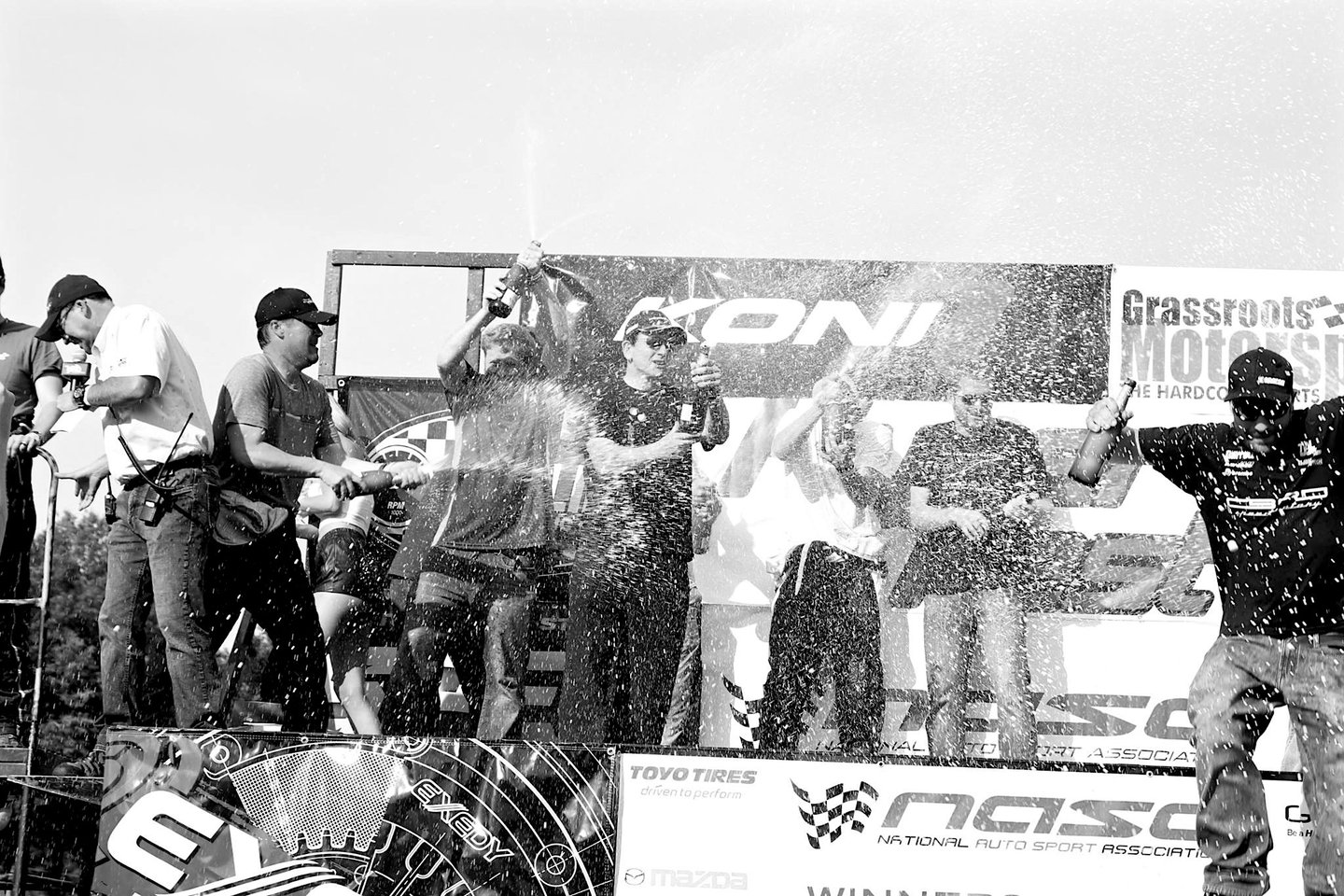 Jason Friday pops champagne on podium