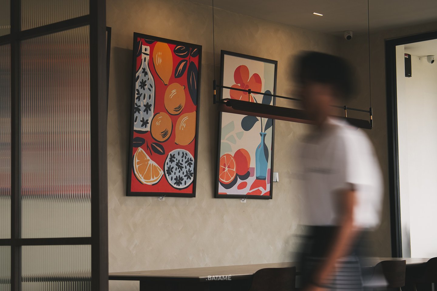 A person passing by in slow shutter with art backgrounds at Ornella Cafe Batam