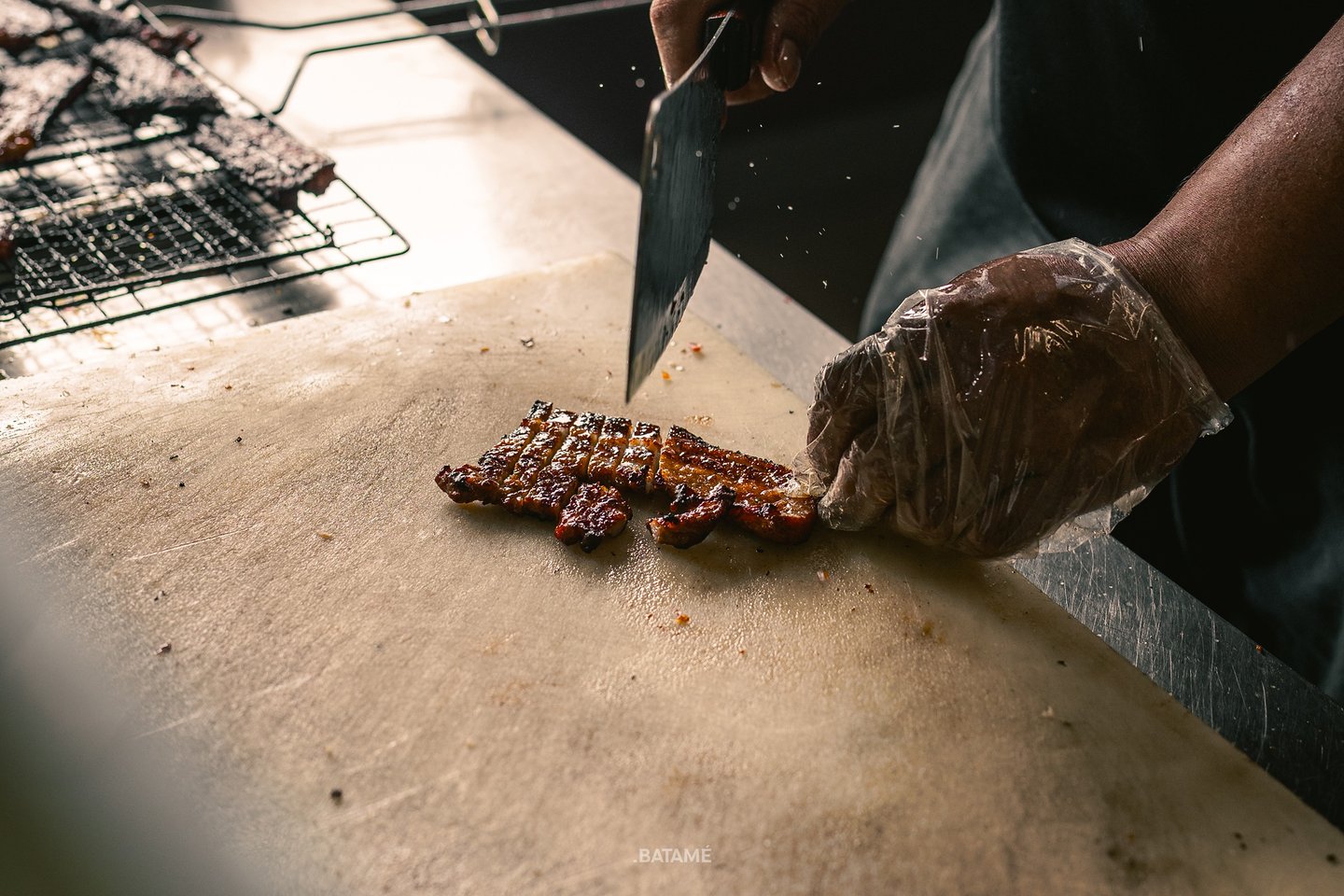 chef chopping grilled pork at BPK Chika Batam