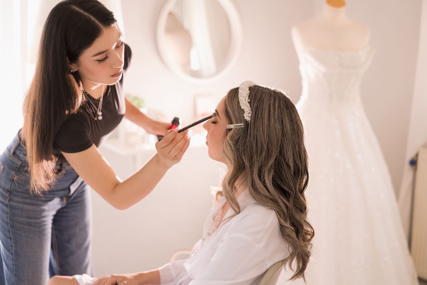 Bride getting her makeup touched up before the ceremony — candid Toronto wedding morning moment