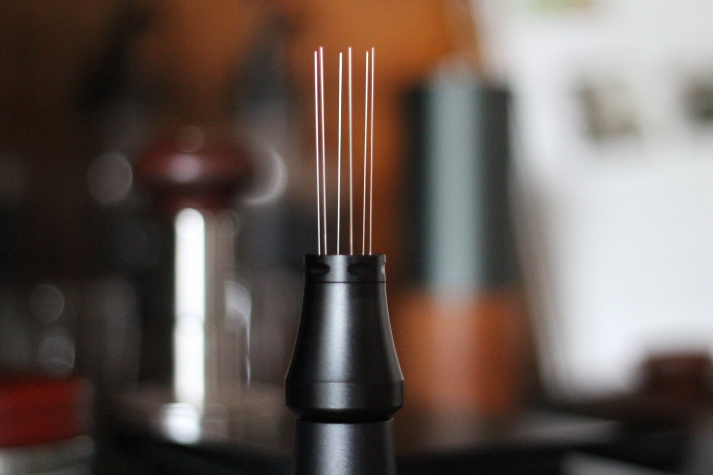 Black espresso WDT tool with stainless steel needles for coffee distribution and declumping.
