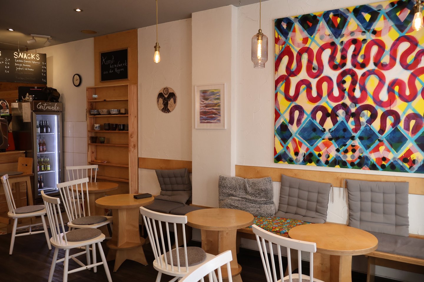 a restaurant with a large painting on the wall