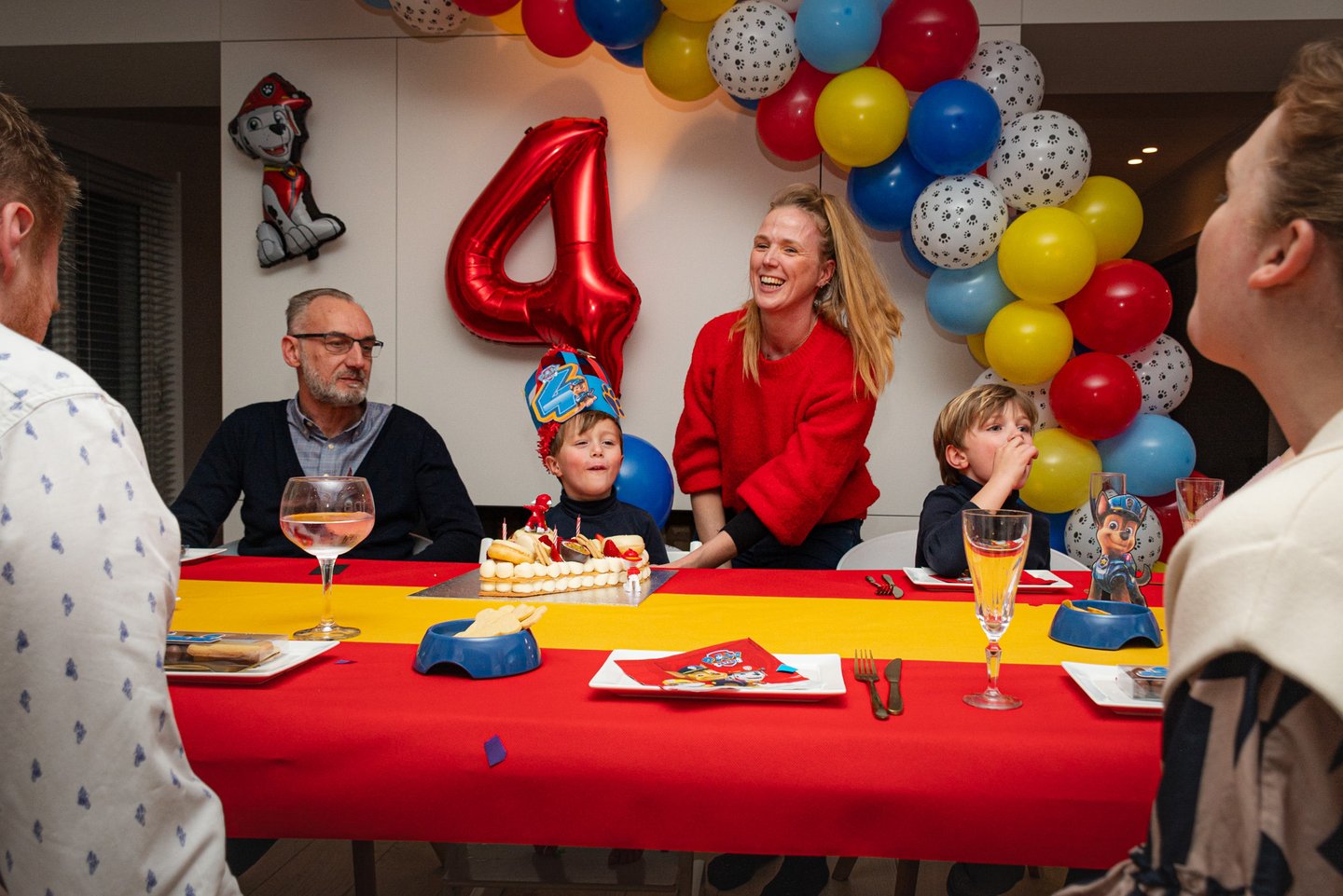 a family celebrating a birthday party with a birthday cake
