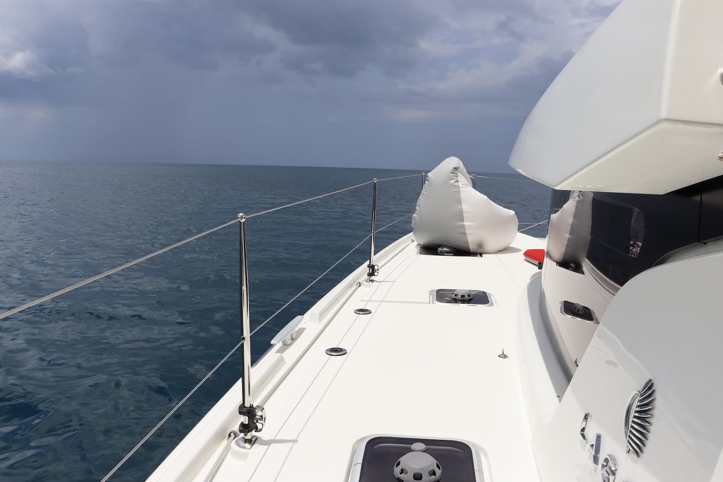 Front deck of Kephas luxury catamaran sailing the Pacific Ocean in Guanacaste