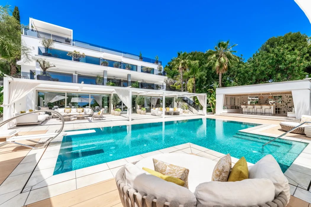 Luxury poolside view of Villa Serenity with palm gardens