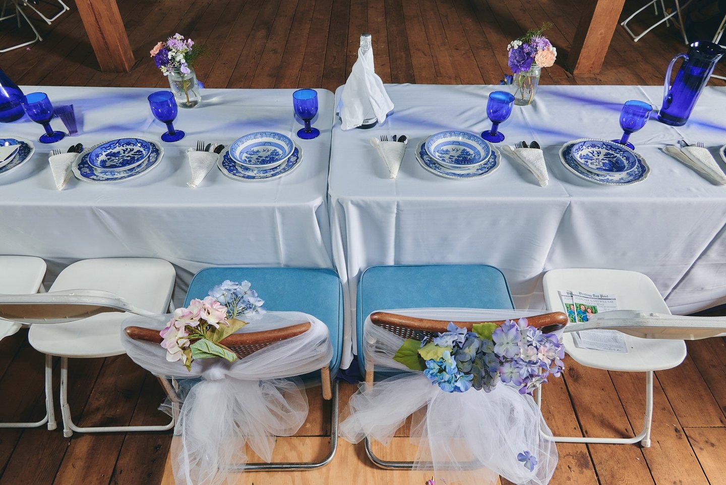 a table with a plate set and flower for a wedding