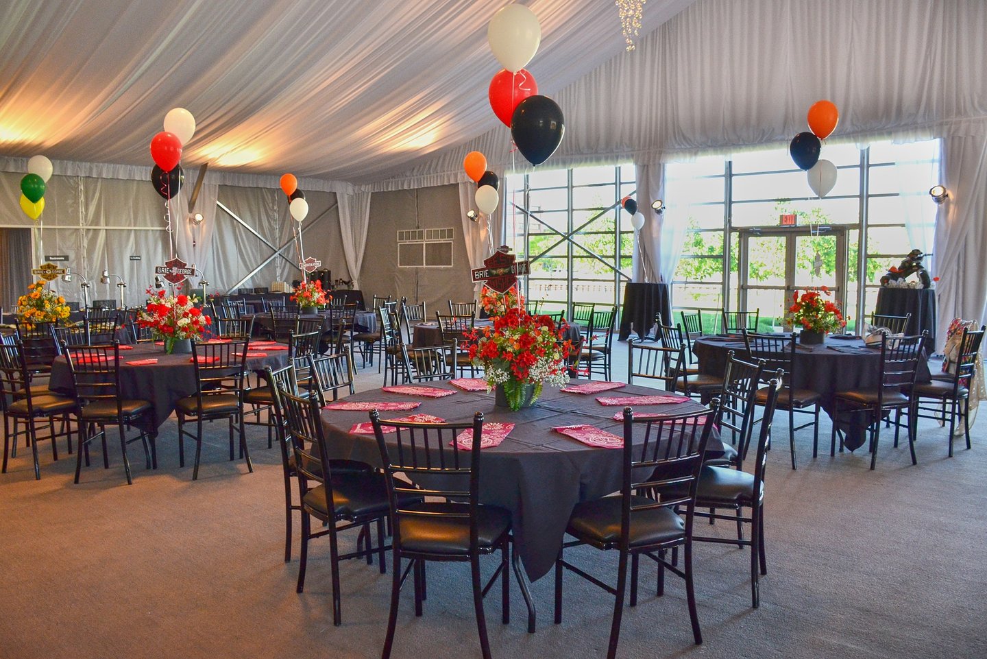 a large room with tables and chairs and balloons and flower decoration