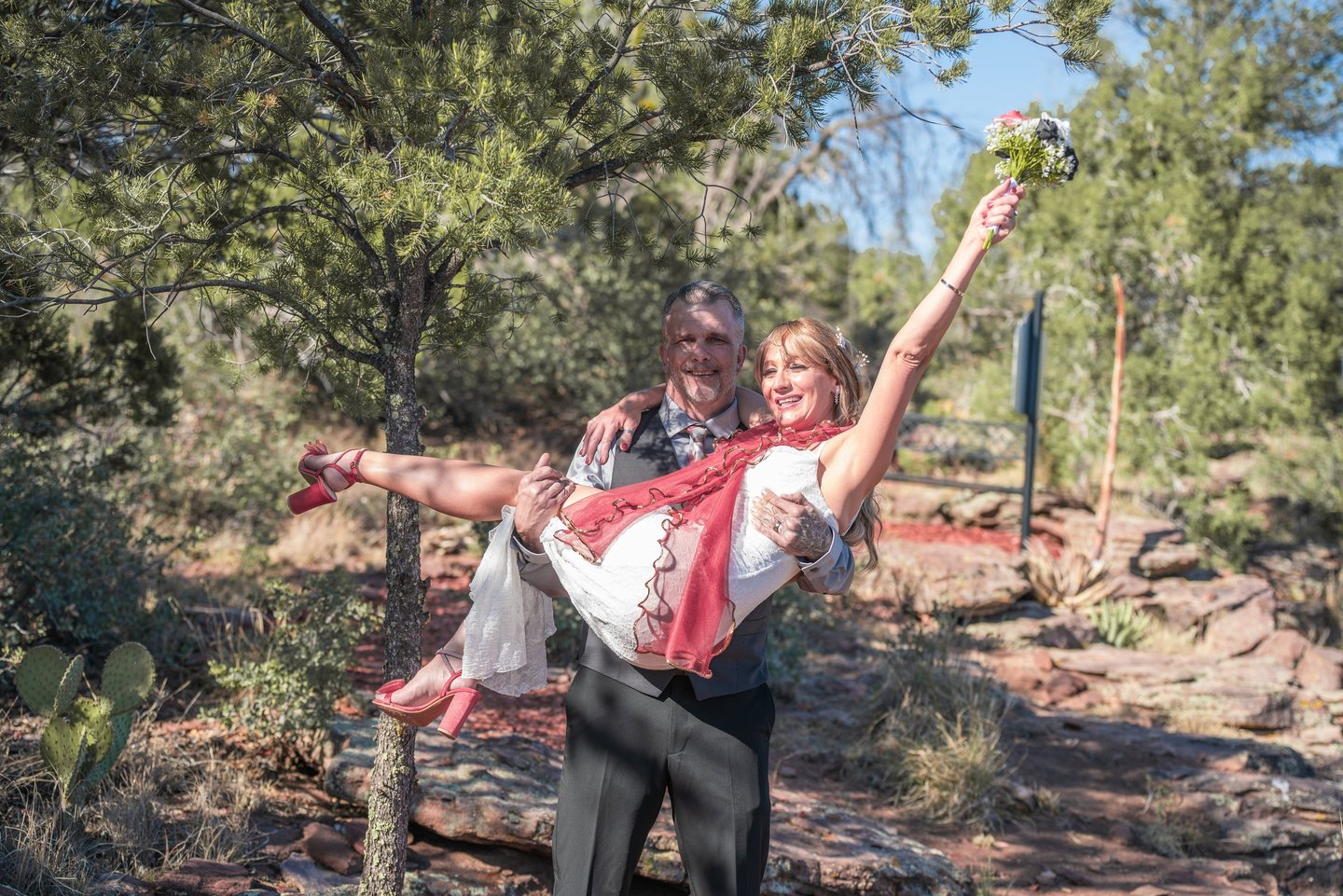 a man and woman are holding a flower