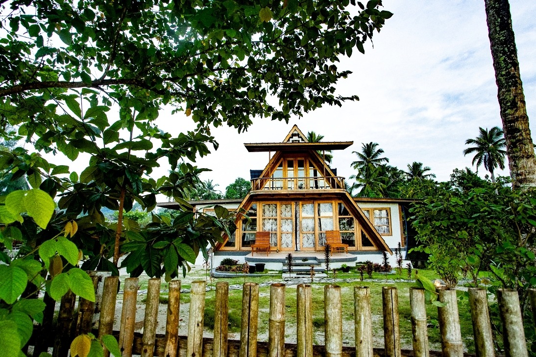 a house with a wooden fence and a wooden fence