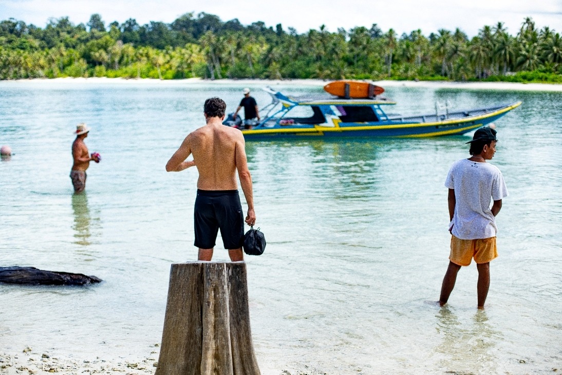 a man standing in the water with a helmet on