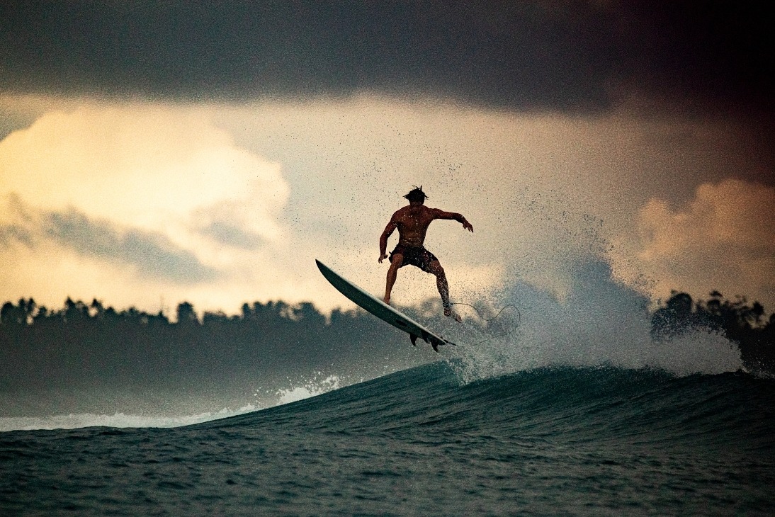 a man is surfing on a wave in the ocean