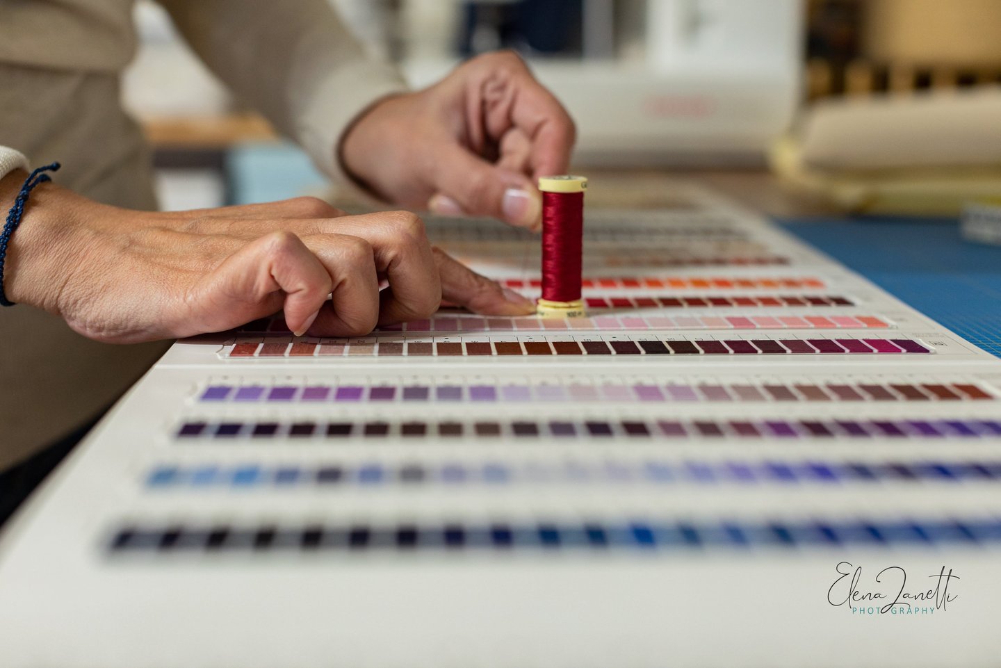 a person is holding a needle and thread thread