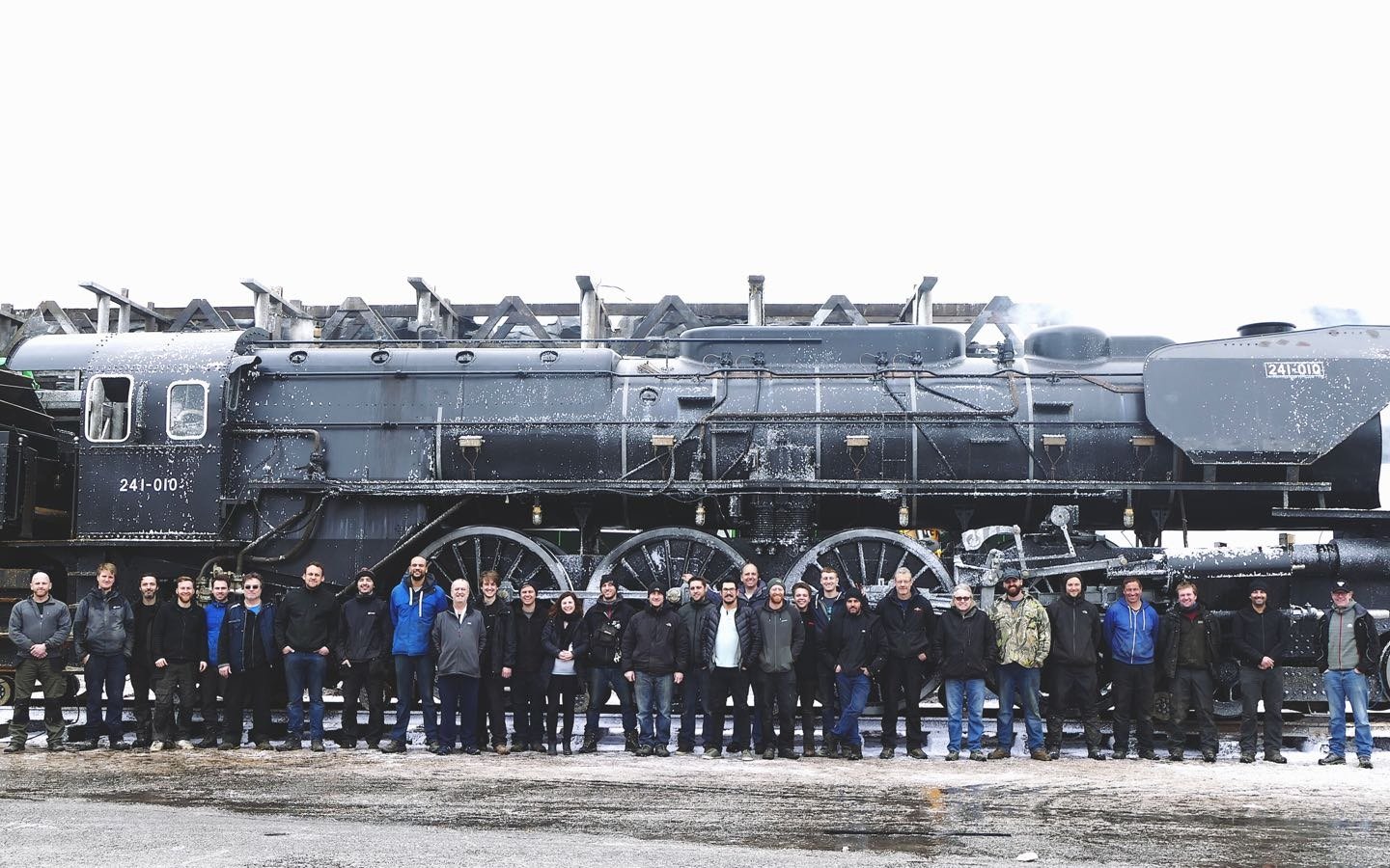 a group of people standing in front of a train