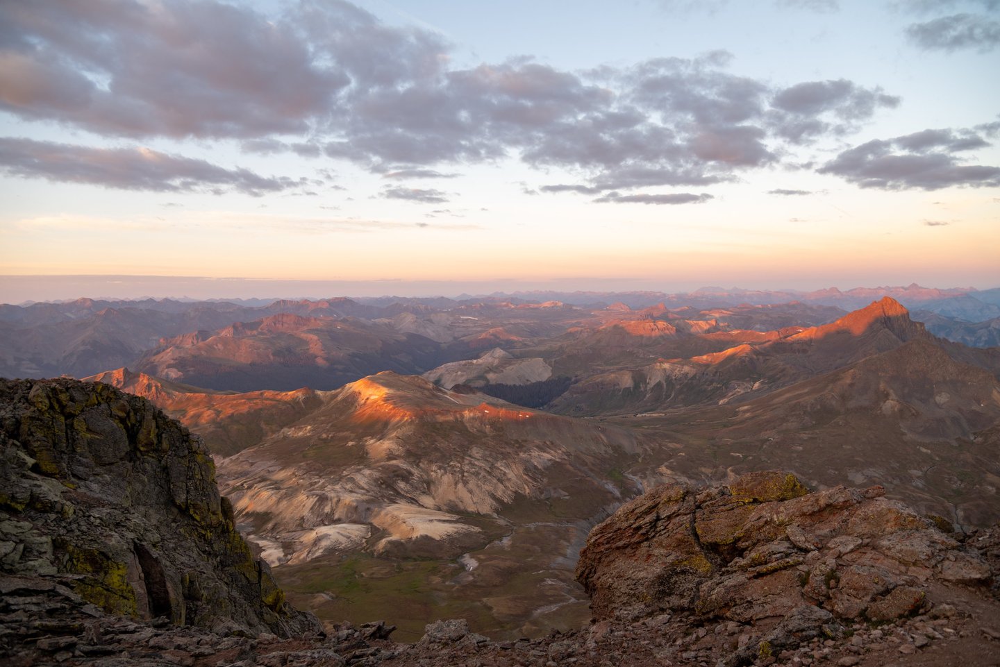 Uncompahgre summit sunrise: alpen glow shines on Wetterhorn Peak and the San Juan Mountains