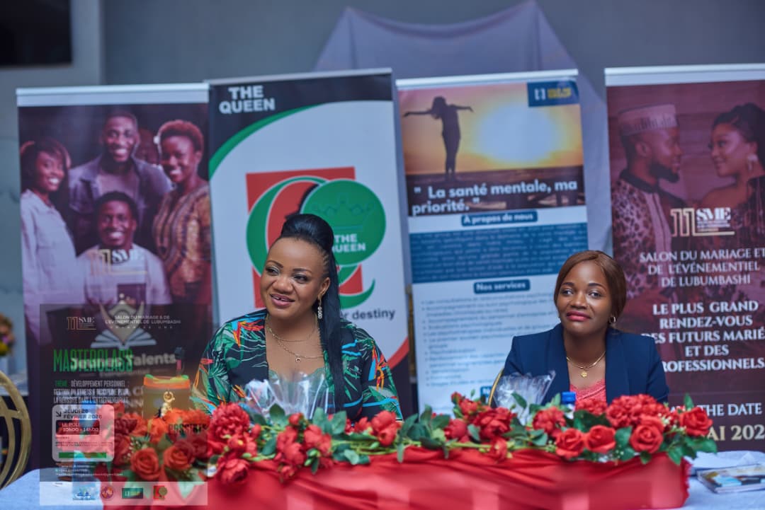 Two professional women sit at a decorated table during an event for mental health in lubumbashi
