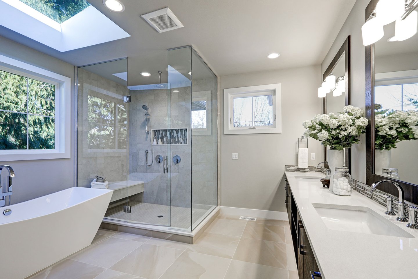 Cozy bathroom with warm lighting, a freestanding tub, and elegant tile work.