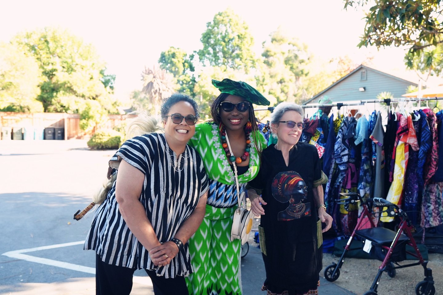 two women standing in front of a rack of clothes
