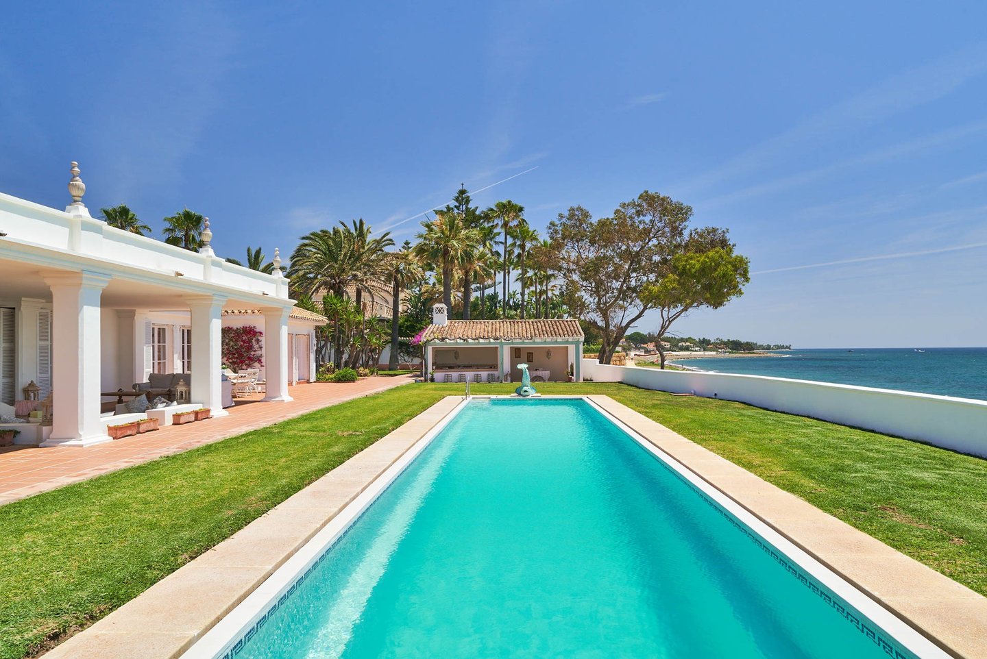Beachfront pool and lawn overlooking the sea