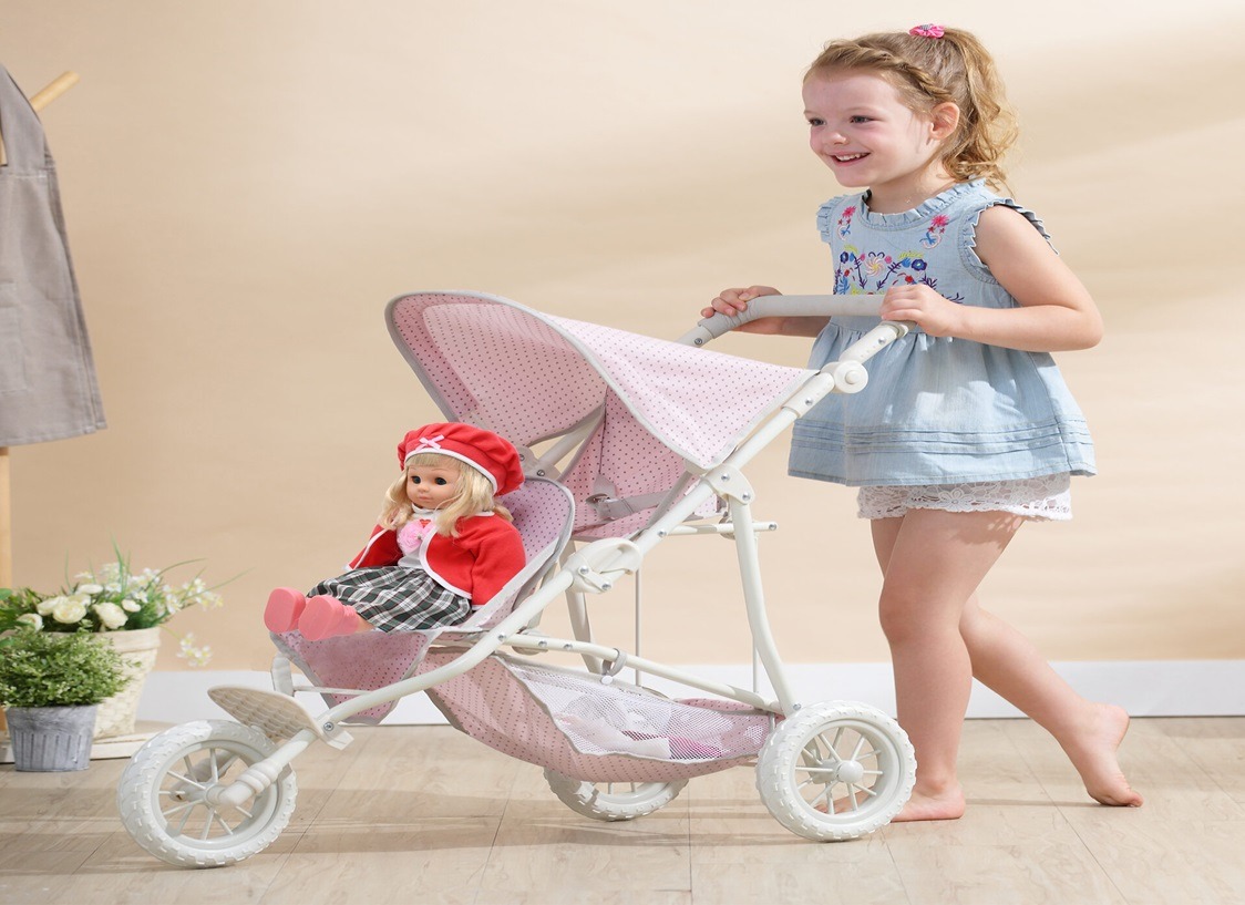 a little girl in a blue dress and a doll doll