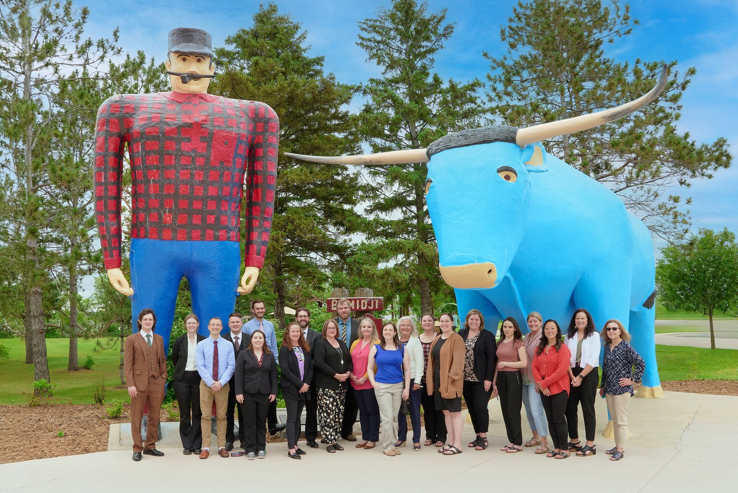 a group of people standing in front of Paul & Babe in Bemidji
