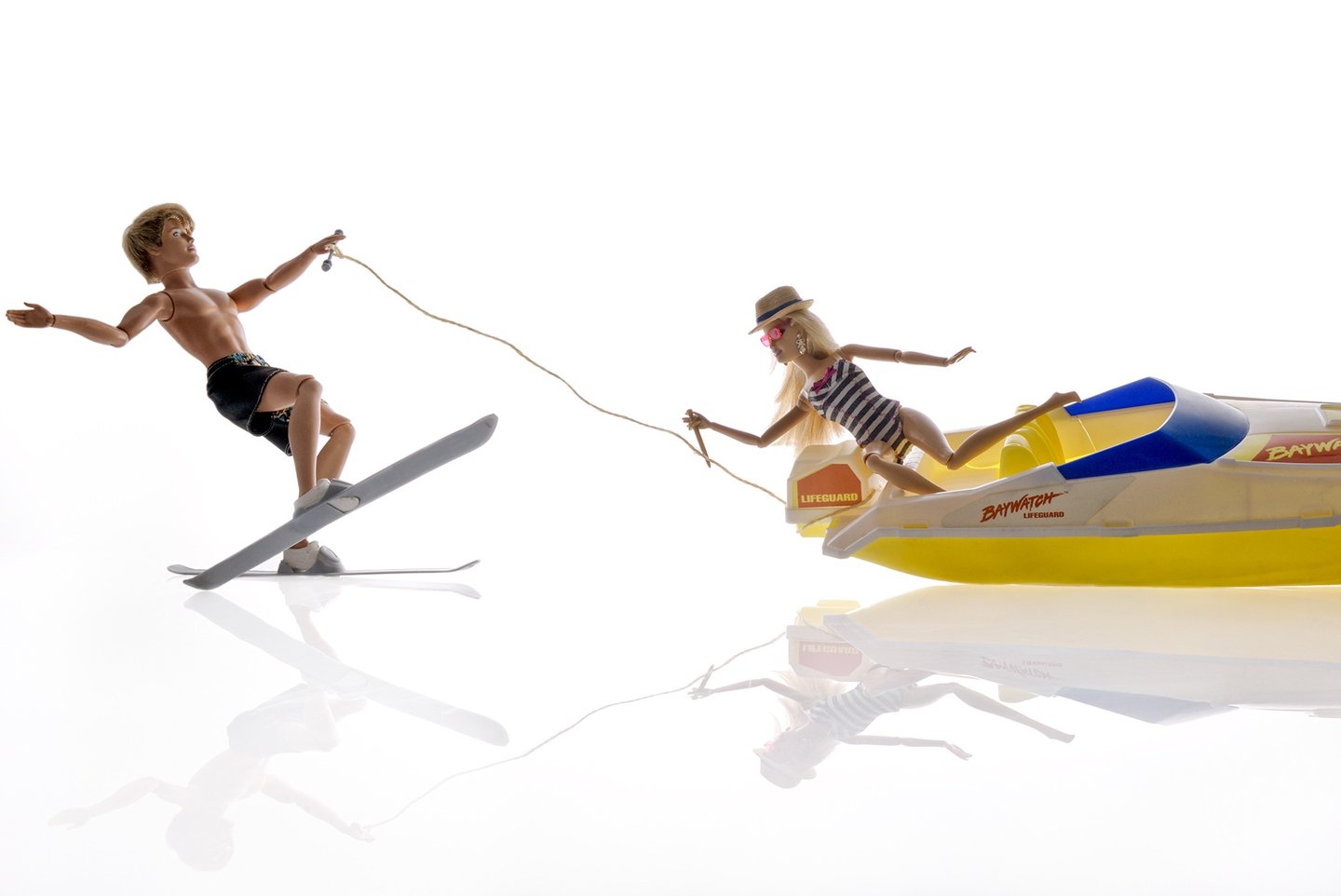 a boy and a girl are skiing on a sunny day