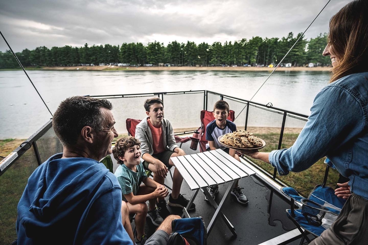 a family eating cookies on an RV deck