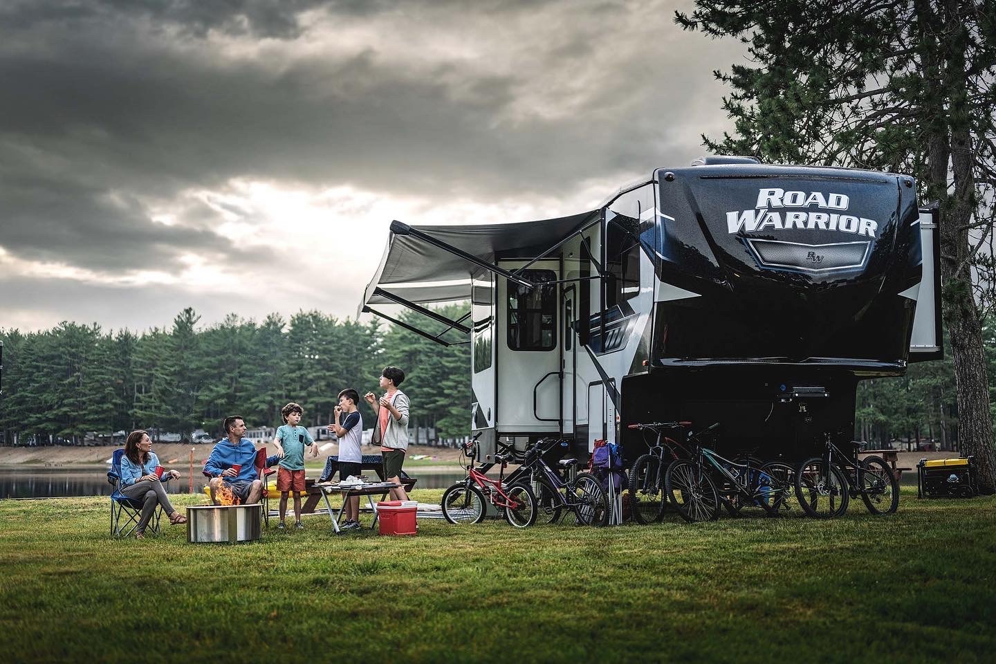 a group of people sitting around a campervan