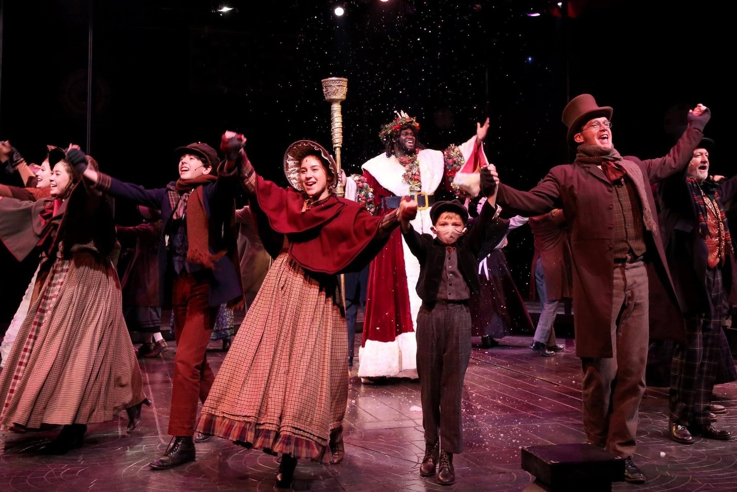 a group of people standing on a stage dancing