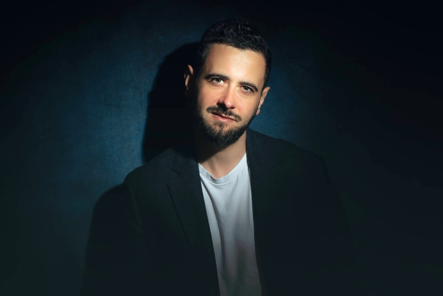 a man in a suit and white shirt