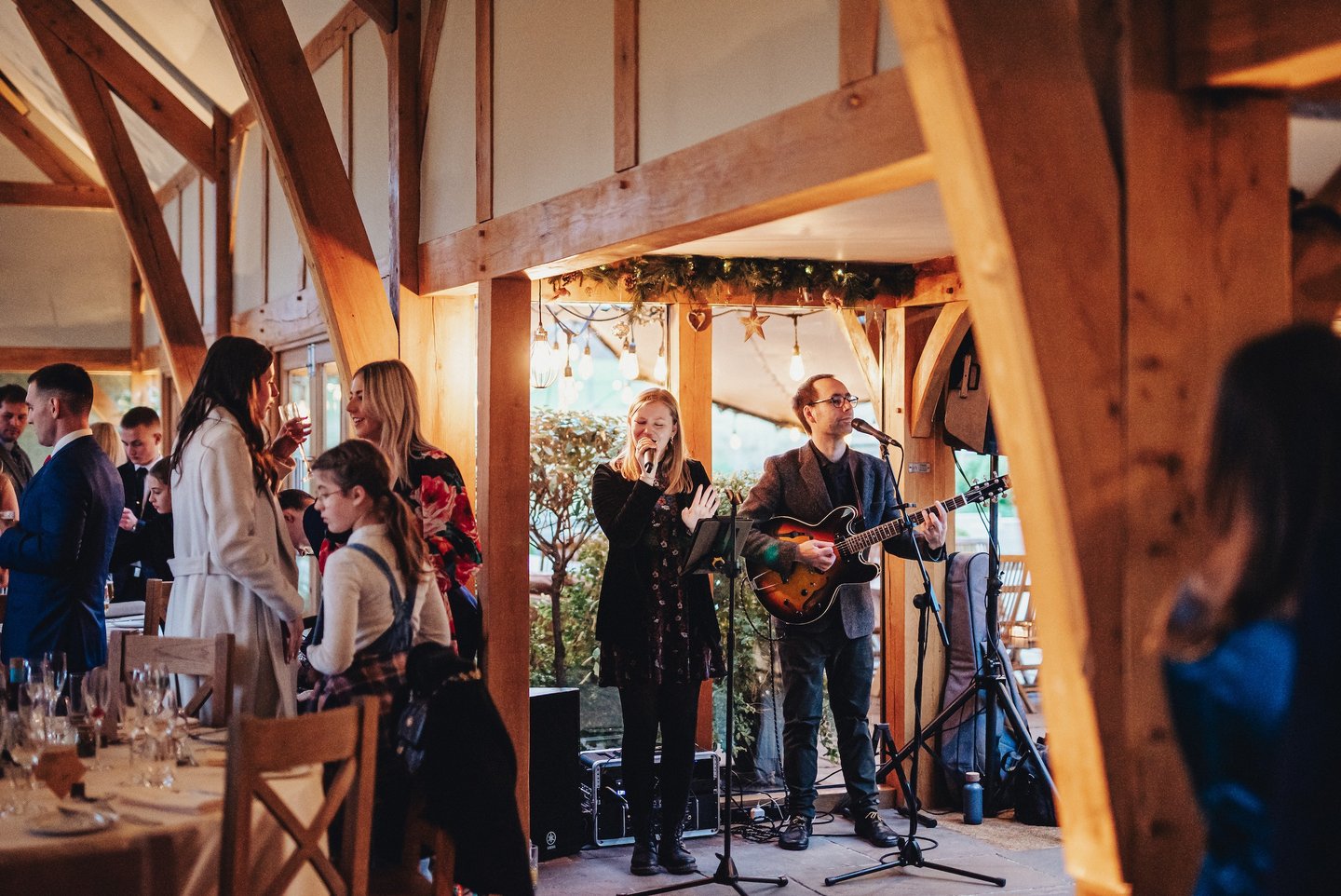 singer and guitarist in wedding barn for reception