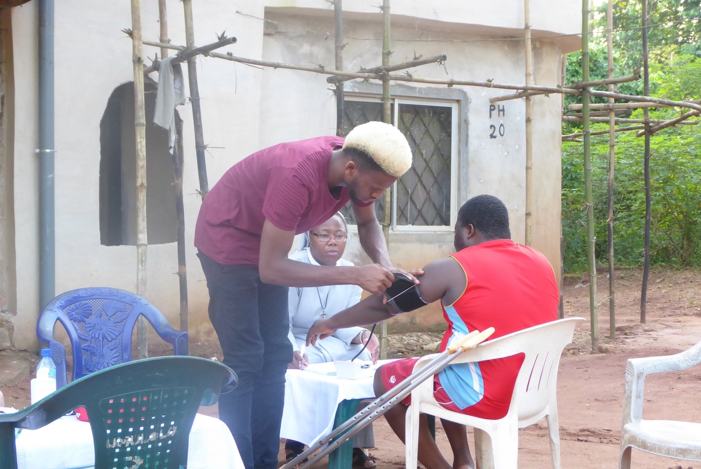 Missionary sister assisting community member during outreach service