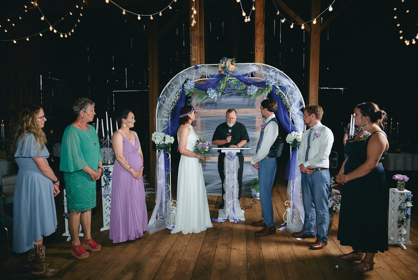 a bride and a groom getting married in a barn