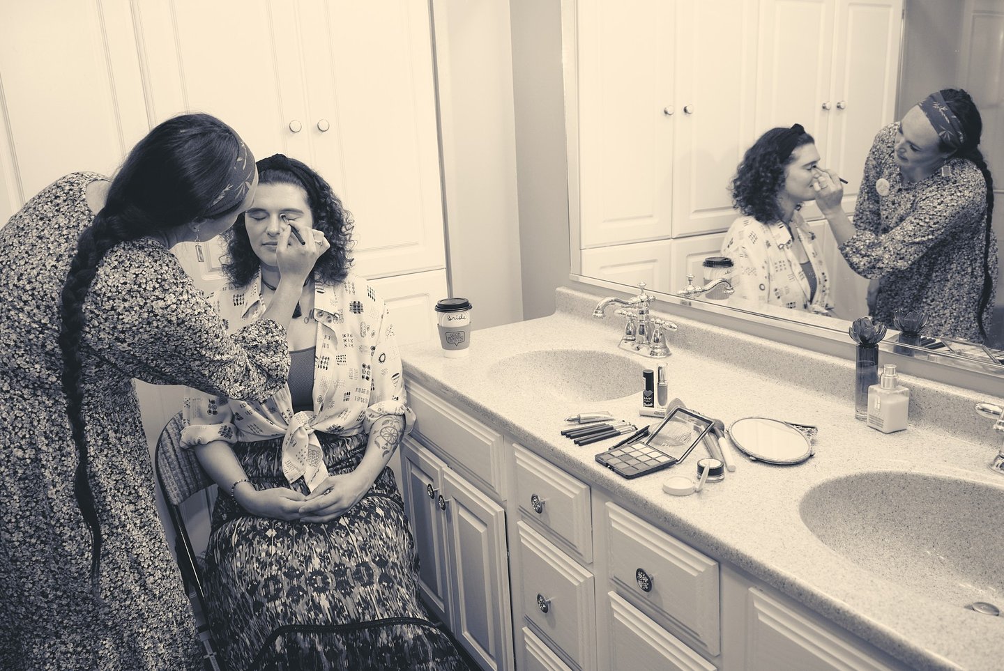 a woman in a floral dress is having makeup and getting ready to be a bride