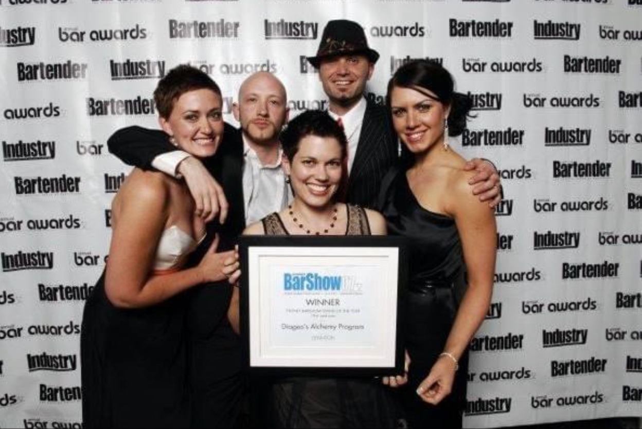 a group of people posing for a photo, they won an award