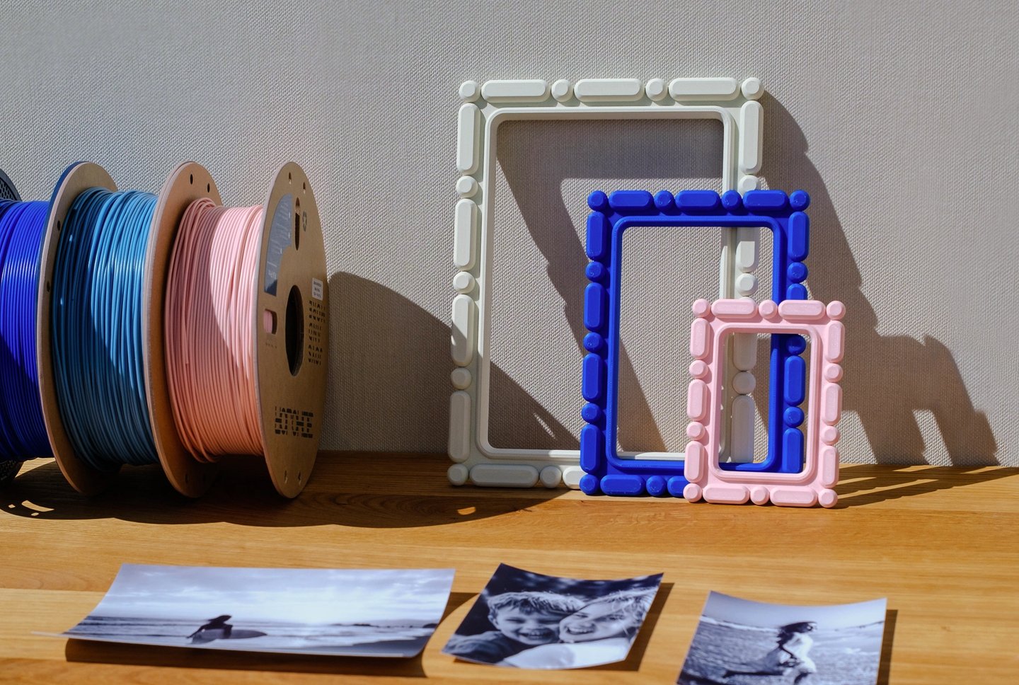     Customizable 3D printed photo frames placed on a wall in a home decor scene