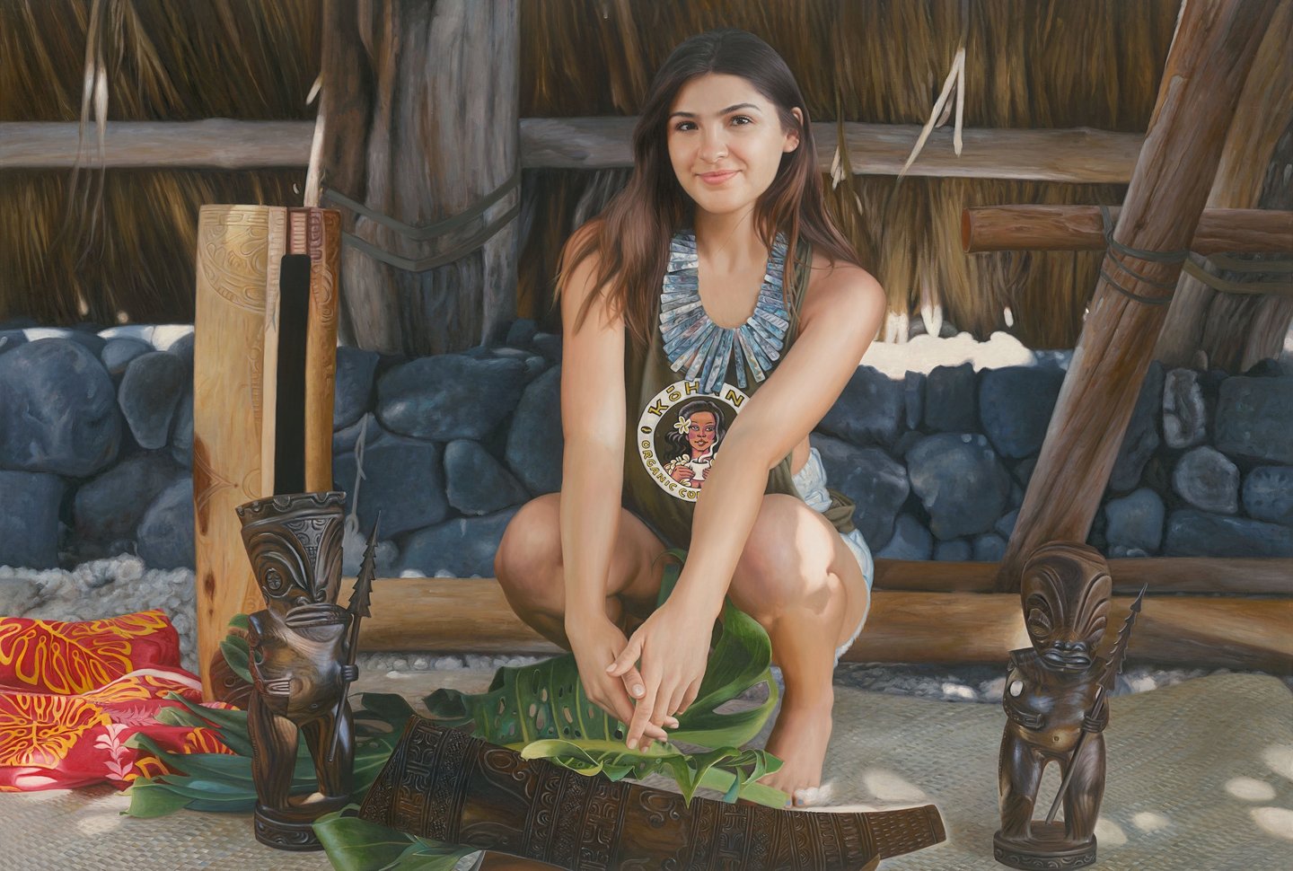 Young woman crouching by traditional Hawaiian tiki carvings and tropical leaves in a tiki hut.